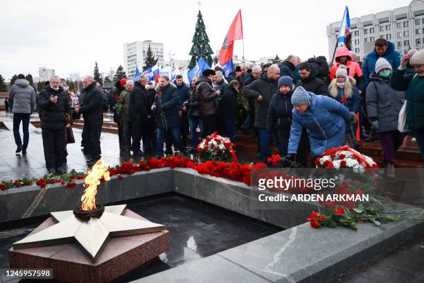 Mourners gather to lay flowers in memory of more than 60 Russian soldiers that Russia says were killed in a Ukrainian strike on Russian-controlled...