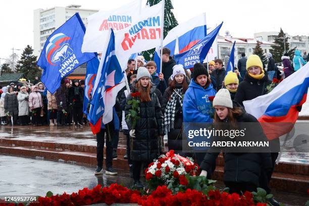 Mourners gather to lay flowers in memory of more than 60 Russian soldiers that Russia says were killed in a Ukrainian strike on Russian-controlled...