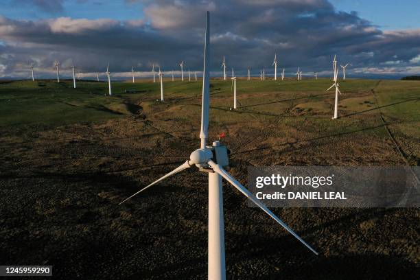 An aerial view shows wind turbines at an onshore wind farm in Llandinam, central Wales, on January 2, 2023.