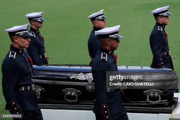 The coffin of the late Brazilian football star Pele is transported outside the Urbano Caldeira stadium to a firetruck in order to begin a funeral...