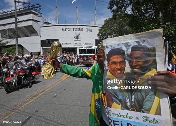 Fan of the late Brazilian football star Pele gathers outside the Urbano Caldeira stadium as a firetruck transports Pele's coffin to the Santos'...