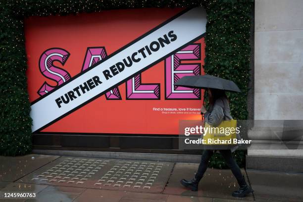 On the first day back to work after the Christmas and New Year holidays, a shopper walks past the exterior of Selfridges on Oxford Street, on 3rd...