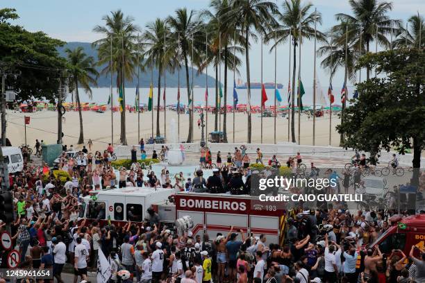 Fans of the late Brazilian football star Pele gather on the street as a firetruck transports Pele's coffin to the Santos' Memorial Cemetery in...