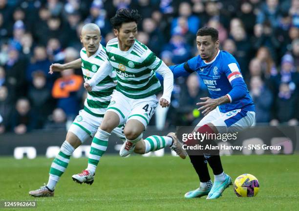 Rangers' James Tavernier tackles Celtic's Reo Hatate during a cinch Premiership match between Rangers and Celtic at Ibrox Stadium, on January 02 in...