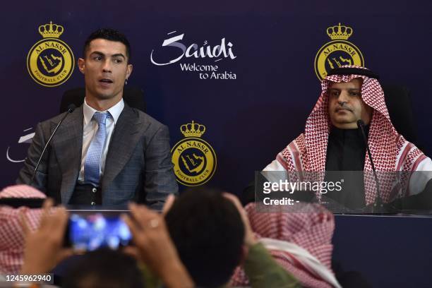 Portuguese forward Cristiano Ronaldo and President of Al-Nassr Musalli Al-Muammar attend a press conference at the Mrsool Park Stadium in the Saudi...