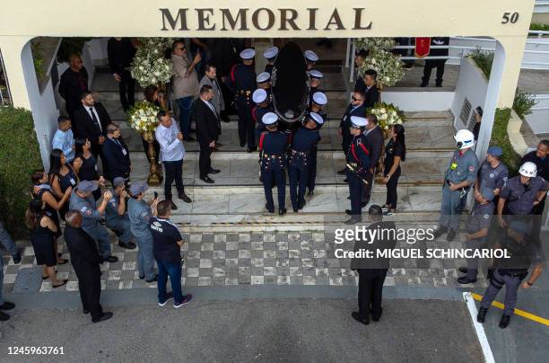 The coffin of the late Brazilian football star Pele is transported to the Santos' Memorial Cemetery after the funeral procession in Santos, Sao Paulo...