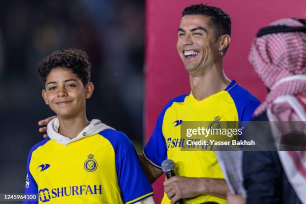 Cristiano Ronaldo and his son Cristiano Ronaldo Jr greet the crowd during the official unveiling of Cristiano Ronaldo as an Al Nassr player at Mrsool...