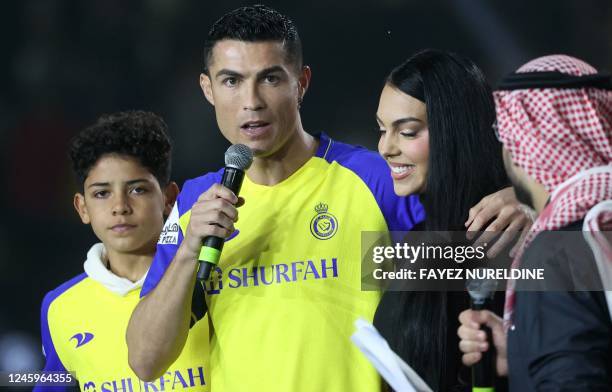 Portuguese forward Cristiano Ronaldo , accompanied by his partner Georgina Rodriguez and his son Cristiano Ronaldo Jr, greets the crowd at the Mrsool...