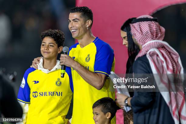 Cristiano Ronaldo accompanied by his partner Georgina Rodriguez and his son Cristiano Ronaldo Jr, greet the crowd during the official unveiling of...