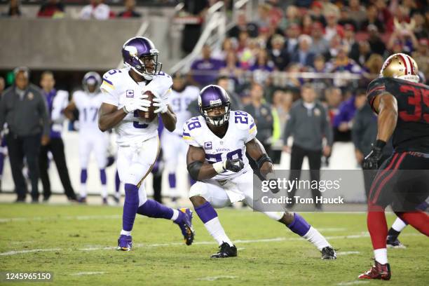 Minnesota Vikings running back Adrian Peterson blocks opponent from Minnesota Vikings quarterback Teddy Bridgewater during an NFL football game...