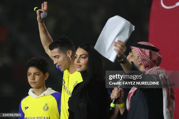 Al-Nassr's new Portuguese forward Cristiano Ronaldo , his partner Georgina Rodriguez and his son Cristiano Ronaldo Jr take the stage during the...