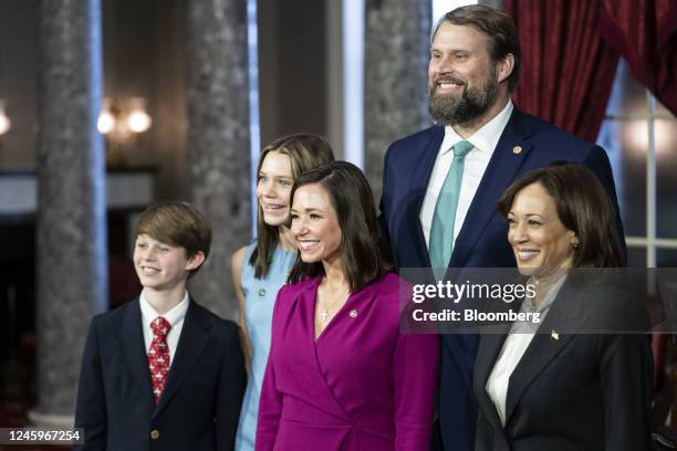 Senator Katie Britt, a Republican from Alabama, center, stands with her family for a photograph with US Vice President Kamala Harris, right,...
