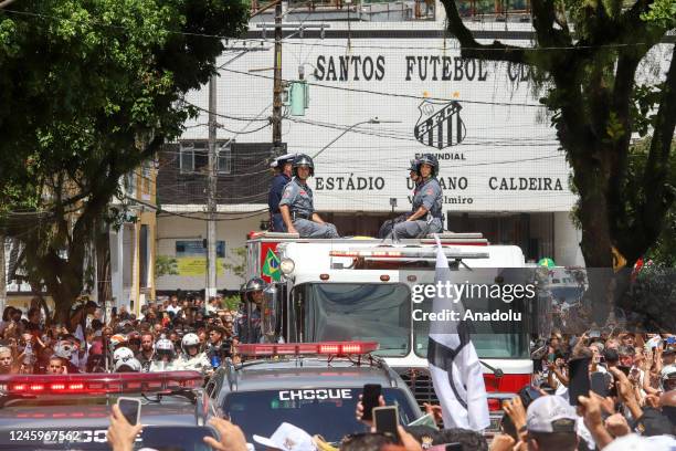 Brazilian football legend Pele being transported atop a fire truck in a funeral procession through the streets of Santos on the way to Peleâs final...