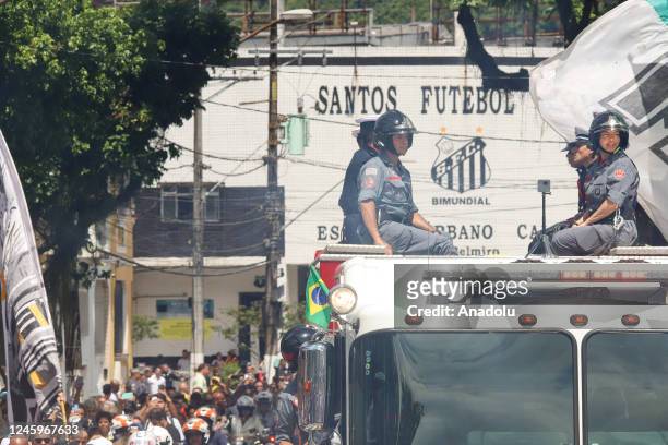 Brazilian football legend Pele being transported atop a fire truck in a funeral procession through the streets of Santos on the way to Peleâs final...
