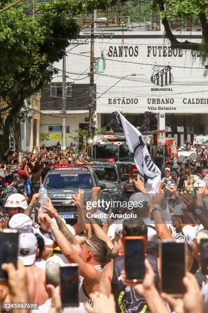 Brazilian football legend Pele being transported atop a fire truck in a funeral procession through the streets of Santos on the way to Peleâs final...