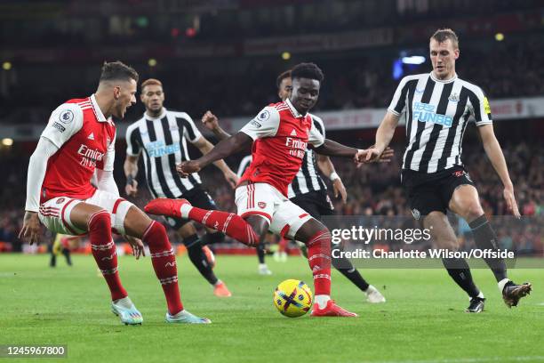 Bukayo Saka of Arsenal is closed down by Dan Burn of Newcastle United during the Premier League match between Arsenal FC and Newcastle United at...