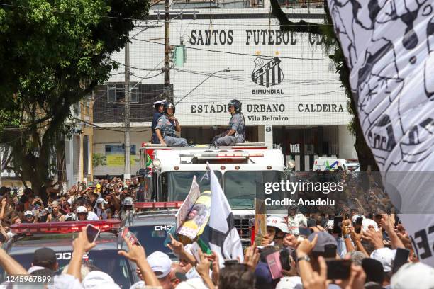 Brazilian football legend Pele being transported atop a fire truck in a funeral procession through the streets of Santos on the way to Peleâs final...