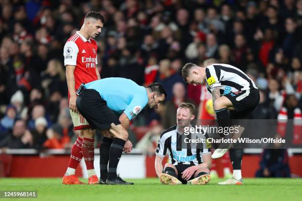 Sean Longstaff of Newcastle United goes down injured during the Premier League match between Arsenal FC and Newcastle United at Emirates Stadium on...