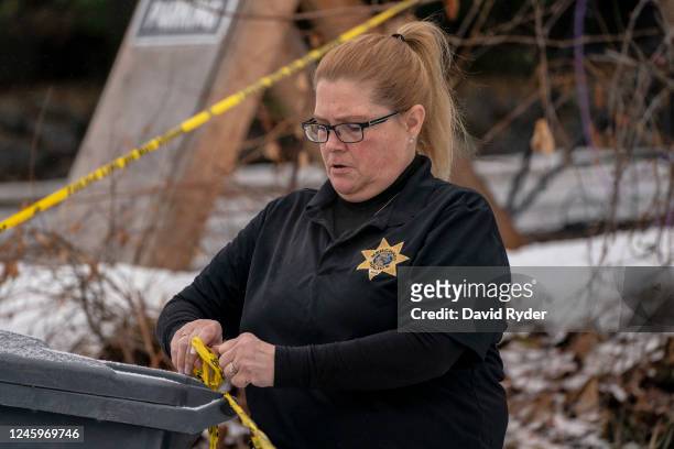 Law enforcement officer secures police tape at the site of a quadruple murder on January 3, 2023 in Moscow, Idaho. A suspect has been arrested for...