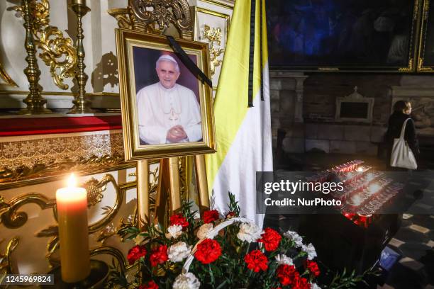 The Corpus Christi Basilica commemorates the late Pope Emeritus Benedict XVI displaying his portrait picture with a black ribbon next to the papal...