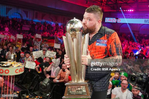 Michael Smith of England poses with the Sid Waddell Trophy during Day Seven of the Cazoo World Darts Championship at Alexandra Palace on December 21,...
