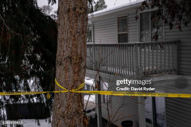 Police tape is seen at the back of a home that is the site of a quadruple murder on January 3, 2023 in Moscow, Idaho. A suspect has been arrested for...