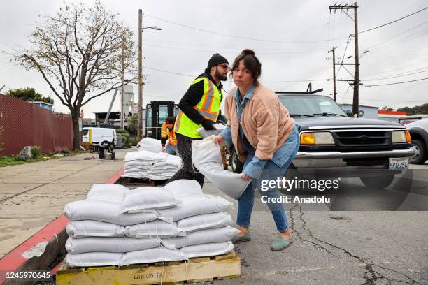 San Franciscans lined up with their cars and rush to get sandbags outside of the Department of Public Works on January 3, 2023 ahead of tomorrow's...