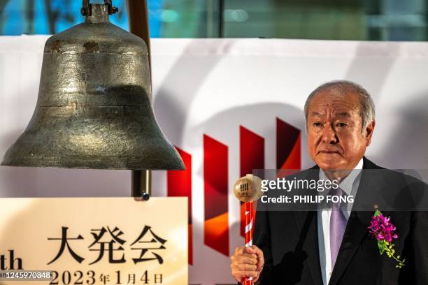 Japan's Finance Minister Shun'ichi Suzuki hits the bell during the opening of the stock market for the new year at the Tokyo Stock Exchange in Tokyo...