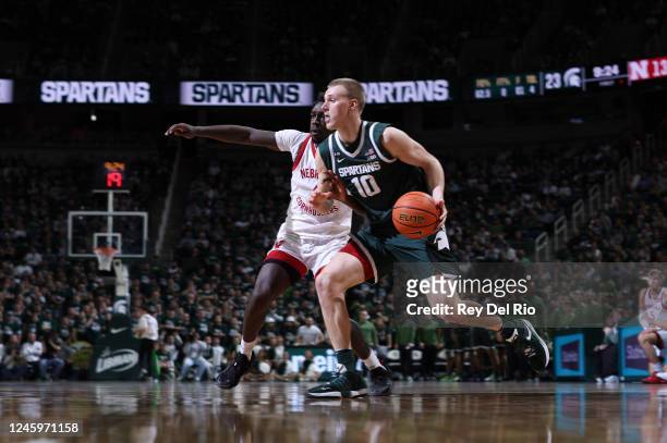 Joey Hauser of the Michigan State Spartans drives past Juwan Gary of the Nebraska Cornhuskers during the first half at Breslin Center on January 3,...