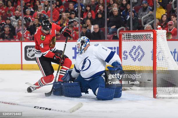 Seth Jones of the Chicago Blackhawks scores on goalie Brian Elliott of the Tampa Bay Lightning in the first period at United Center on January 03,...