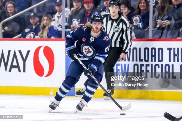 Kyle Connor of the Winnipeg Jets plays the puck down the ice during first period action against the Calgary Flames at the Canada Life Centre on...