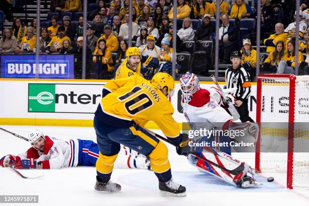 Colton Sissons of the Nashville Predators scores off a crossing pass from Filip Forsberg as Joel Edmundson and Sam Montembeault of the Montreal...