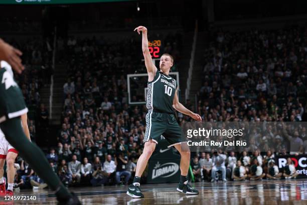 Joey Hauser of the Michigan State Spartans follows through on a three-point shot during the first half against the Nebraska Cornhuskers at Breslin...