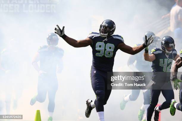 Seattle Seahawks defensive end Greg Scruggs runs through the tunnel onto the field against the Dallas Cowboys during an NFL game in Seattle,...