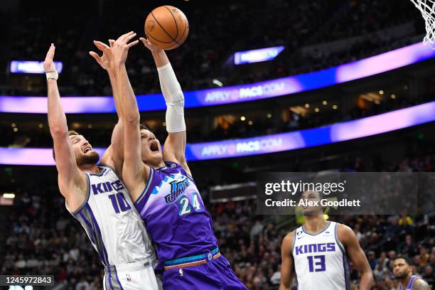 Walker Kessler of the Utah Jazz attempts a rebound with Domantas Sabonis of the Sacramento Kings during the first half of a game at Vivint Arena on...