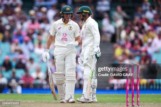 Australias Marnus Labuschagne speaks with Usman Khawaja during day one of the third cricket Test match between Australia and South Africa at the...