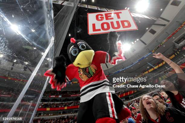 The Chicago Blackhawks mascot "Tommy Hawk" holds a sign during the game between the Chicago Blackhawks and the Tampa Bay Lightning at United Center...