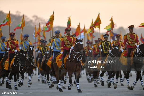 Soldiers on horseback lead the convoy of Myanmar military chief Min Aung Hlaing as he arrives at the parade ground to mark the country's Independence...