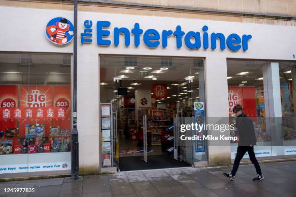Person out and about in the city centre passes The Entertainer toy shop on 29th December 2022 in Bath, United Kingdom. Bath is a city in the county...