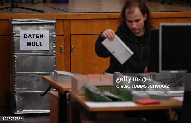 Volunteer works on letters for the postal voting as preparations are under way for repeated elections, on January 4, 2023 in Berlin. - Repeated...