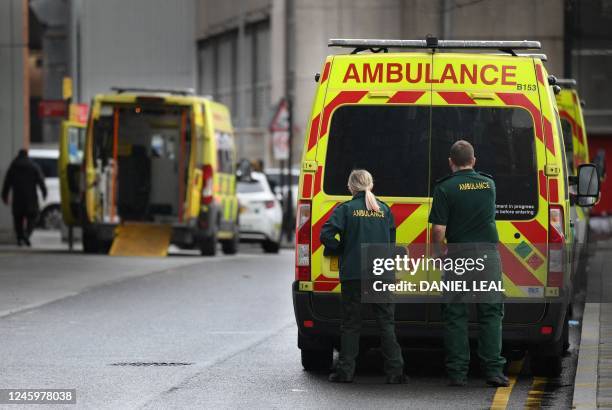 Ambulance staff stand outside the Royal London hospital in east London on January 4, 2023. - UK medical bodies said patients were dying due to...