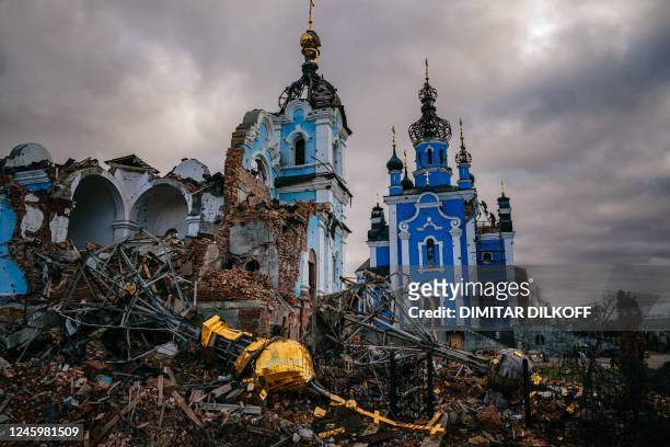 Construction workers climb onto the roof of a destroyed church in the village of Bohorodychne, Donetsk region on January 4 amid the Russian invasion...