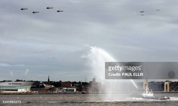 Military aircraft fly over the Liverpool skyline and British aircraft carrier HMS Illustrious in the River Mersey in Liverpool, north-west England,...