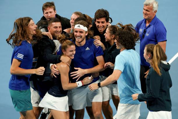 Greece's Maria Sakkari and Stefanos Tsitsipas celebrate with teammates their win over Croatia's Petra Martic and Borna Gojo at the end of their mixed...