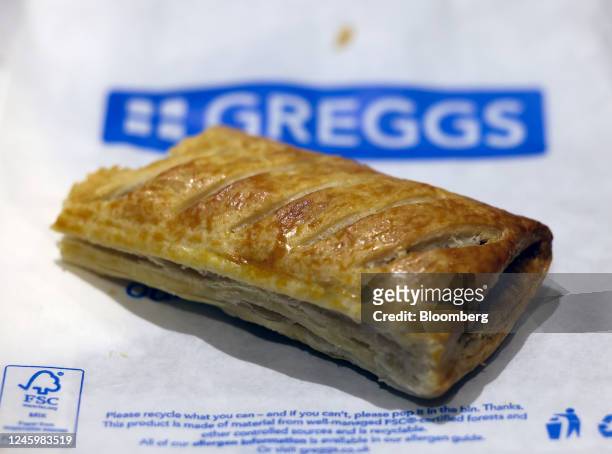 Sausage roll on a branded bag inside a Greggs Plc bakery in Bury St. Edmunds, UK, on Wednesday, Jan. 4, 2023. Sandwich chain Greggs will...