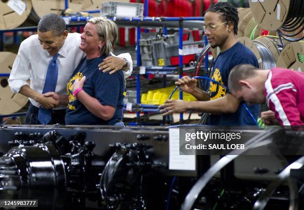 President Barack Obama greets employees during a tour of the Daimler Trucks North America Manufacturing plant prior to speaking on the economy and...