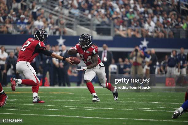 Atlanta Falcons running back Devonta Freeman receives ball from teammate Atlanta Falcons quarterback Matt Ryan during an NFL football game between...