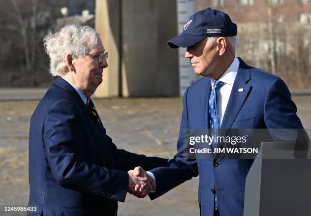 President Joe Biden shakes hands with Senate Minority Leader Mitch McConnell during an event about the bipartisan infrastructure law in front of the...