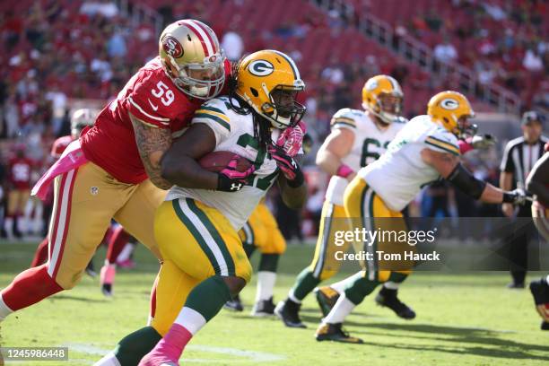 Green Bay Packers running back Eddie Lacy and San Francisco 49ers outside linebacker Aaron Lynch in action during an NFL football game between the...