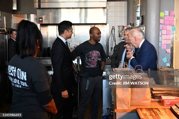 President Joe Biden samples peach cobbler with Cincinnati mayor Aftab Pureval at Just Q'in barbecue restaurant in Cincinnati, Ohio,, on January 4,...